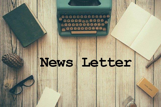 Newsletter, a table and a typewriter